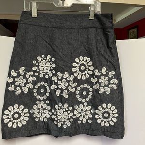 Ann Taylor Petites short skirt in dusty blue with floral embroidery.  Size 0.